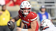 Oct 4, 2025; Louisville, Kentucky, USA; Virginia Cavaliers defensive end Mitchell Melton (17) sacks Louisville Cardinals quarterback Miller Moss (7) during the second half at L&N Federal Credit Union Stadium. Virginia defeated Louisville 30-27. Mandatory Credit: Jamie Rhodes-Imagn Images