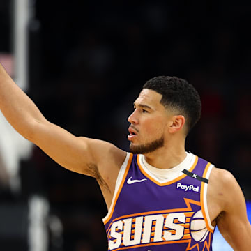 Mar 24, 2025; Phoenix, Arizona, USA; Phoenix Suns guard Devin Booker (1) reacts against the Milwaukee Bucks at Footprint Center. Mandatory Credit: Mark J. Rebilas-Imagn Images