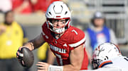 Oct 4, 2025; Louisville, Kentucky, USA; Virginia Cavaliers defensive end Mitchell Melton (17) sacks Louisville Cardinals quarterback Miller Moss (7) during the second half at L&N Federal Credit Union Stadium. Virginia defeated Louisville 30-27. Mandatory Credit: Jamie Rhodes-Imagn Images