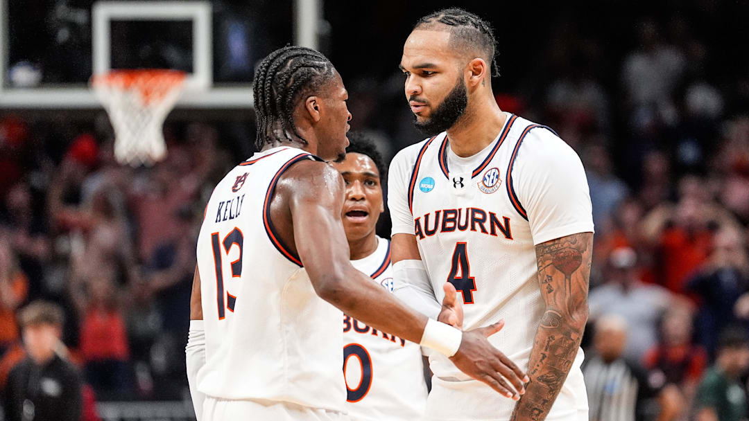 Auburn forward Johni Broome (4) celebrates a play against Michigan State with guard Miles Kelly (13), left, and guard Tahaad Pettiford (0), center, during the first half of the Elite Eight round of NCAA tournament at State Farm Arena in Atlanta, Ga. on Sunday, March 30, 2025.