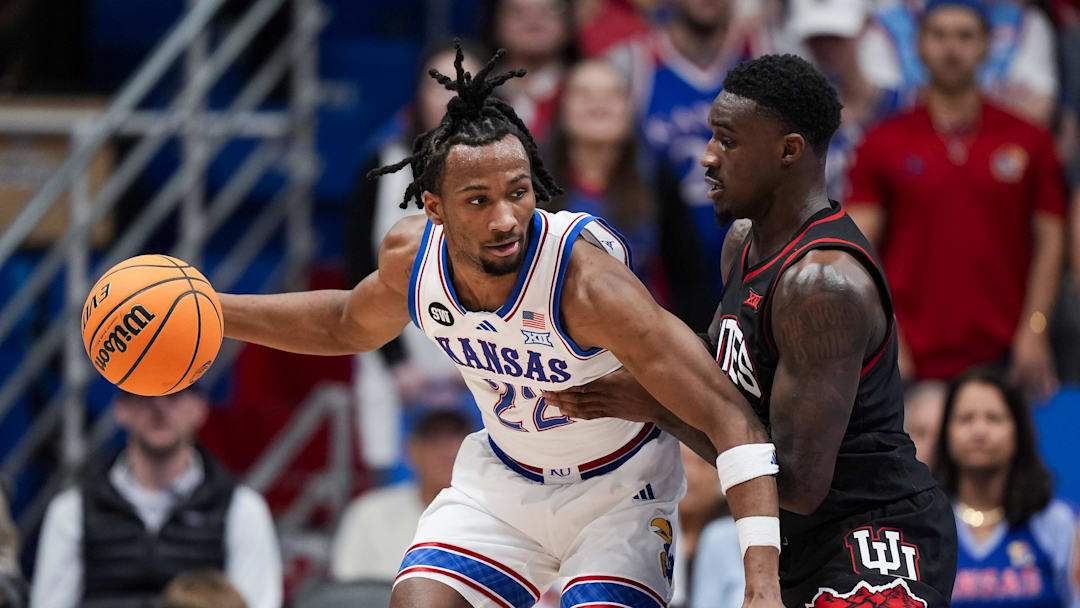 Feb 7, 2026; Lawrence, Kansas, USA; Kansas Jayhawks guard Darryn Peterson (22) drives against Utah Utes forward Seydou Traore (0) during the first half at Allen Fieldhouse. Mandatory Credit: Jay Biggerstaff-Imagn Images