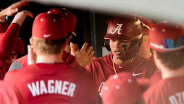 Feb 14, 2025; Tuscaloosa, AL, USA; Justin Lebron is congratulated in the dugout after scoring the Tide’s first run of the season during Alabama baseball’s opening day at Sewell-Thomas Stadium against Bradley. The Crimson Tide defeated Bradley 10-6.