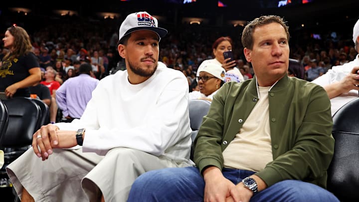 Jun 30, 2024; Phoenix, Arizona, USA; Phoenix Suns guard Devon Booker sits with Phoenix Mercury owner Mat Ishbia during the game between the Indiana Fever and the Phoenix Mercury at Footprint Center. Mandatory Credit: Mark J. Rebilas-Imagn Images