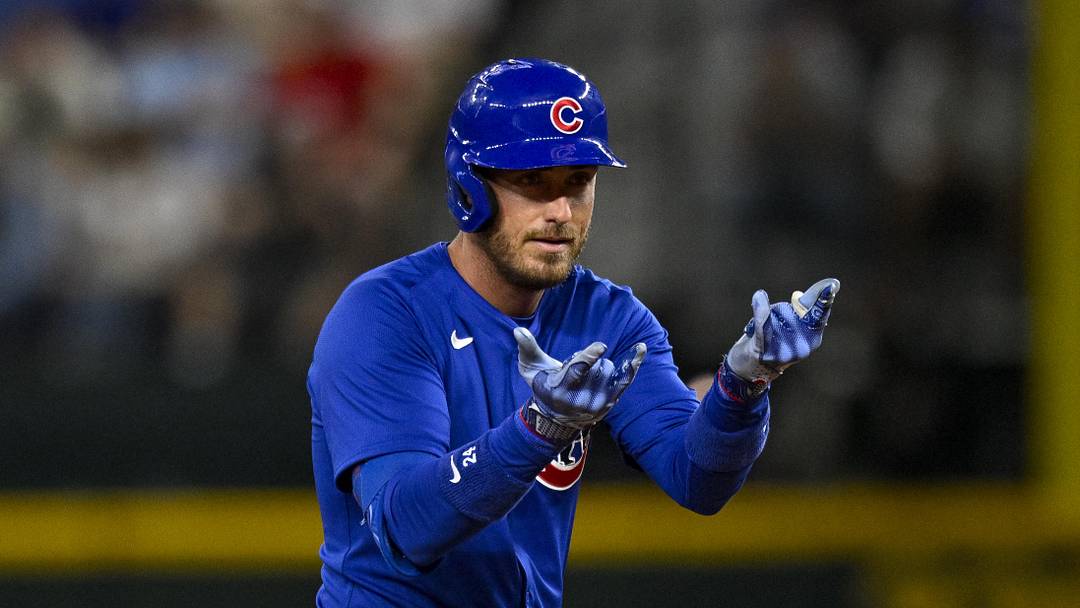 Mar 28, 2024; Arlington, Texas, USA; Chicago Cubs center fielder Cody Bellinger (24) celebrates at second base after he hits a double and drives in a run against the Texas Rangers during the sixth inning at Globe Life Field.