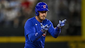 Mar 28, 2024; Arlington, Texas, USA; Chicago Cubs center fielder Cody Bellinger (24) celebrates at second base after he hits a double and drives in a run against the Texas Rangers during the sixth inning at Globe Life Field.