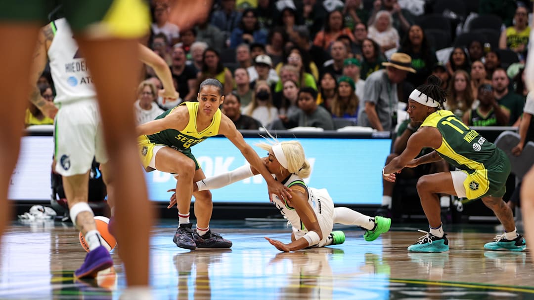 Aug 5, 2025; Seattle, Washington, USA; Seattle Storm guard Skylar Diggins (4) and  Minnesota Lynx guard Dijonia Carrington (3) scramble for a loose ball during the second half at Climate Pledge Arena. Mandatory Credit: Kevin Ng-Imagn Images
