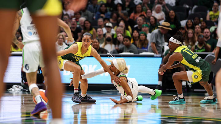 Aug 5, 2025; Seattle, Washington, USA; Seattle Storm guard Skylar Diggins (4) and  Minnesota Lynx guard Dijonia Carrington (3) scramble for a loose ball during the second half at Climate Pledge Arena. Mandatory Credit: Kevin Ng-Imagn Images