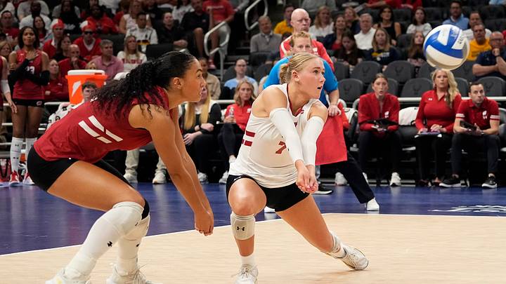 Wisconsin Badgers outside hitter Grace Egan (32) and libero/defensive specialist Kristen Simon (7) prepare to hit a bump during the first set of the match against the Marquette Golden Eagles on Wednesday September 17, 2025 at Fiserv Forum in Milwaukee, Wisconsin.