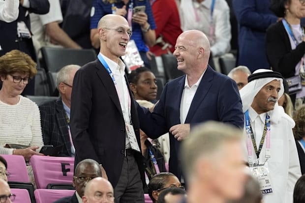 NBA commissioner Adam Silver and FIFA president Gianni Infantino look on in the first half in the men's basketball gold medal