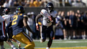 Nov 1, 2025; Berkeley, California, USA; Virginia Cavaliers running back J'Mari Taylor (3) runs the ball against defensive back Dru Polidore Jr. (2) during the first quarter at California Memorial Stadium. Mandatory Credit: D. Ross Cameron-Imagn Images