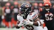 Nov 2, 2025; Cincinnati, Ohio, USA; Chicago Bears running back Kyle Monangai (25) runs with the ball against Cincinnati Bengals defensive end Cedric Johnson (52) during the first quarter at Paycor Stadium. 