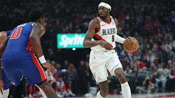 Mar 9, 2025; Portland, Oregon, USA;  Portland Trail Blazers forward Jerami Grant (9) brings the ball up the court against Detroit Pistons center Jalen Duren (0) in the first half at Moda Center. Mandatory Credit: Jaime Valdez-Imagn Images