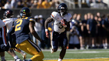 Nov 1, 2025; Berkeley, California, USA; Virginia Cavaliers running back J'Mari Taylor (3) runs the ball against defensive back Dru Polidore Jr. (2) during the first quarter at California Memorial Stadium. Mandatory Credit: D. Ross Cameron-Imagn Images