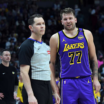 Feb 22, 2025; Denver, Colorado, USA; Los Angeles Lakers guard Luka Doncic (77) talks with an official during a stoppage in play in the first half at Ball Arena. Mandatory Credit: Christopher Hanewinckel-Imagn Images