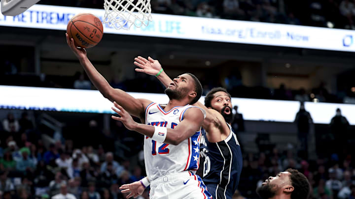 Mar 16, 2025; Dallas, Texas, USA;  Philadelphia 76ers guard Jared Butler (12) shoots past Dallas Mavericks guard Spencer Dinwiddie (26) during the second half at American Airlines Center. Mandatory Credit: Kevin Jairaj-Imagn Images