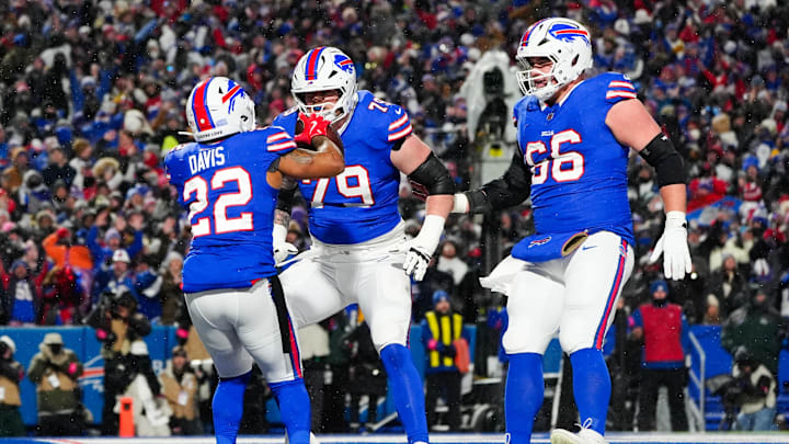 Jan 19, 2025; Orchard Park, New York, USA; Buffalo Bills running back Ray Davis (22) celebrates with Buffalo Bills offensive tackle Spencer Brown (79) and Buffalo Bills guard Connor McGovern (66) after scoring a touchdown during the first quarter against the Baltimore Ravens in a 2025 AFC divisional round game at Highmark Stadium
