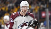 Nov 20, 2023; Nashville, Tennessee, USA; Colorado Avalanche center Ryan Johansen (12) mouths to linesman Bevan Mills (53) after not dropping the puck against the Nashville Predators during the second period at Bridgestone Arena. Mandatory Credit: Steve Roberts-Imagn Images