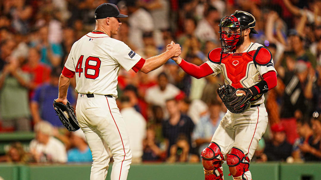 Jul 11, 2024; Boston, Massachusetts, USA; Boston Red Sox relief pitcher Chase Anderson (48) and catcher Connor Wong (12) reacts after defeating the Oakland Athletics in nine innings at Fenway Park. Mandatory Credit: David Butler II-Imagn Images