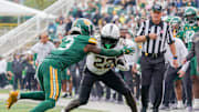 Nov 1, 2025; Waco, Texas, USA; UCF Knights running back Myles Montgomery (22) carries the ball as Baylor Bears safety Devyn Bobby (3) defends during the second half at McLane Stadium. Mandatory Credit: Raymond Carlin III-Imagn Images