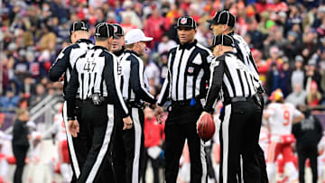 Dec 17, 2023; Foxborough, Massachusetts, USA; NFL referee Shawn Hochuli (83) huddles with his crew during a timeout on the field during the first half of a game between the New England Patriots and the Kansas City Chiefs at Gillette Stadium. Mandatory Credit: Eric Canha-Imagn Images