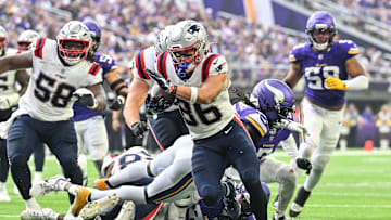Aug 16, 2025; Minneapolis, Minnesota, USA; New England Patriots wide receiver Efton Chism III (86) scores a touchdown as center Jared Wilson (58) looks on during the second quarter at U.S. Bank Stadium. Mandatory Credit: Jeffrey Becker-Imagn Images