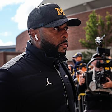 Michigan head coach Sherrone Moore walks off the bus as team arrive before the Texas game at Michigan Stadium in Ann Arbor on Saturday, September 7, 2024.