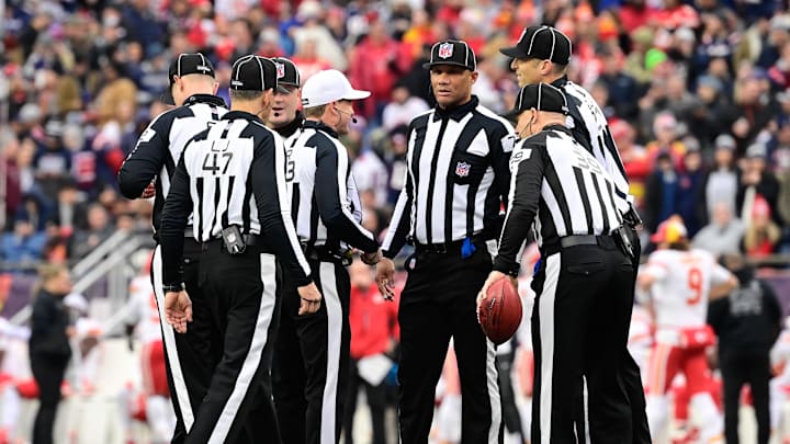 Dec 17, 2023; Foxborough, Massachusetts, USA; NFL referee Shawn Hochuli (83) huddles with his crew during a timeout on the field during the first half of a game between the New England Patriots and the Kansas City Chiefs at Gillette Stadium. Mandatory Credit: Eric Canha-Imagn Images