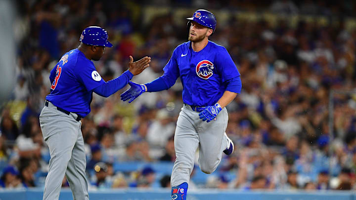 Sep 9, 2024; Los Angeles, California, USA; Chicago Cubs first baseman Michael Busch (29) is greeted by third base coach Willie Harris (33) after hitting a solo home run against the Los Angeles Dodgers during the fourth inning at Dodger Stadium. Mandatory Credit: Gary A. Vasquez-Imagn Images