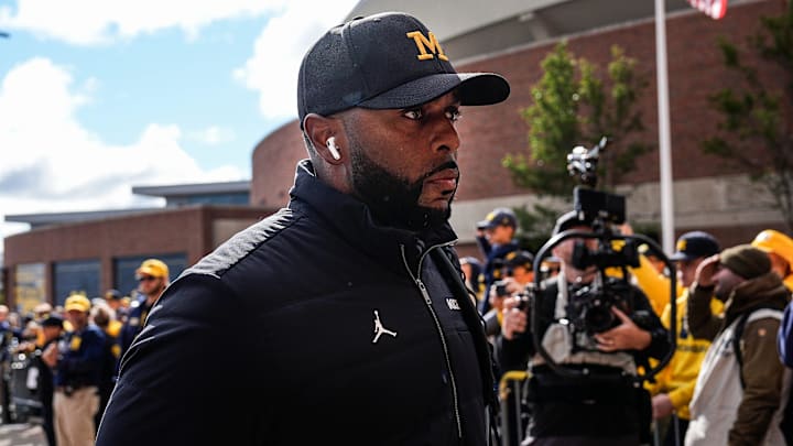 Michigan head coach Sherrone Moore walks off the bus as team arrive before the Texas game at Michigan Stadium in Ann Arbor on Saturday, September 7, 2024.