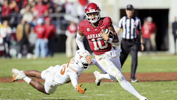 Nov 16, 2024; Fayetteville, Arkansas, USA; Arkansas Razorbacks quarterback Taylen Green (10) rushes in the third quarter as Texas Longhorns defensive back Jelani McDonald (25) defends at Donald W. Reynolds Razorback Stadium. Texas won 20-10. Mandatory Credit: Nelson Chenault-Imagn Images