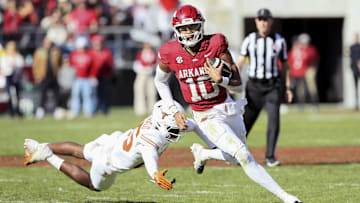 Nov 16, 2024; Fayetteville, Arkansas, USA; Arkansas Razorbacks quarterback Taylen Green (10) rushes in the third quarter as Texas Longhorns defensive back Jelani McDonald (25) defends at Donald W. Reynolds Razorback Stadium. Texas won 20-10. Mandatory Credit: Nelson Chenault-Imagn Images