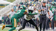Nov 1, 2025; Waco, Texas, USA; UCF Knights running back Myles Montgomery (22) carries the ball as Baylor Bears safety Devyn Bobby (3) defends during the second half at McLane Stadium. Mandatory Credit: Raymond Carlin III-Imagn Images