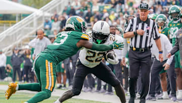 Nov 1, 2025; Waco, Texas, USA; UCF Knights running back Myles Montgomery (22) carries the ball as Baylor Bears safety Devyn Bobby (3) defends during the second half at McLane Stadium. Mandatory Credit: Raymond Carlin III-Imagn Images