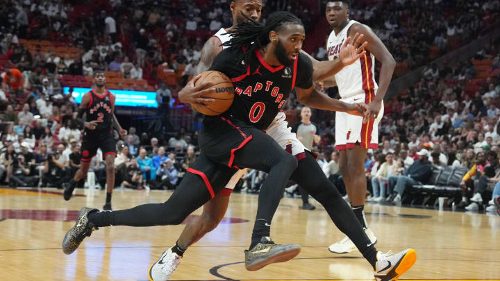 Apr 14, 2024; Miami, Florida, USA;  Toronto Raptors guard Javon Freeman-Liberty (0) drives to the basket as Miami Heat forward Haywood Highsmith (24) defends during the second half at Kaseya Center. Mandatory Credit: Jim Rassol-USA TODAY Sports