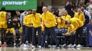 Feb 19, 2025; Morgantown, West Virginia, USA; West Virginia Mountaineers head coach Darian DeVries yells from the bench during the second half against the Cincinnati Bearcats at WVU Coliseum. Mandatory Credit: Ben Queen-Imagn Images