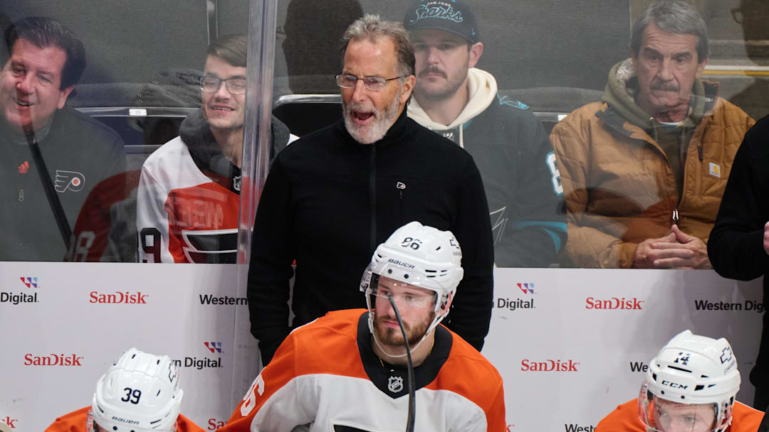Dec 31, 2024; San Jose, California, USA; Philadelphia Flyers head coach John Tortorella reacts to game play against the San Jose Sharks as right wing Matvei Michkov (39), left wing Joel Farabee (86) and center Sean Couturier (14) watch the play during the third period at SAP Center at San Jose. Mandatory Credit: Robert Edwards-Imagn Images