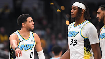 Dec 8, 2024; Indianapolis, Indiana, USA; Indiana Pacers guard Tyrese Haliburton (0) and Indiana Pacers center Myles Turner (33) talk during a timeout during the first half against the Charlotte Hornets at Gainbridge Fieldhouse. Mandatory Credit: Robert Goddin-Imagn Images 