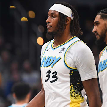 Dec 8, 2024; Indianapolis, Indiana, USA; Indiana Pacers guard Tyrese Haliburton (0) and Indiana Pacers center Myles Turner (33) talk during a timeout during the first half against the Charlotte Hornets at Gainbridge Fieldhouse. Mandatory Credit: Robert Goddin-Imagn Images 