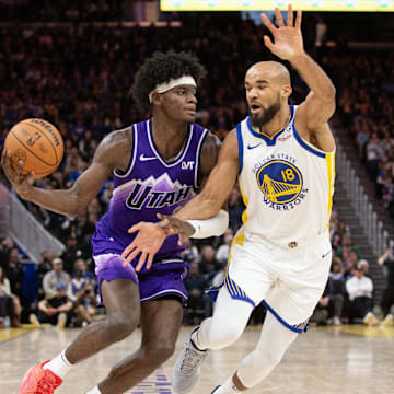 Apr 14, 2024; San Francisco, California, USA; Golden State Warriors guard Jerome Robinson (18) guards Utah Jazz forward Taylor Hendricks (0) during the fourth quarter at Chase Center. Mandatory Credit: D. Ross Cameron-Imagn Images