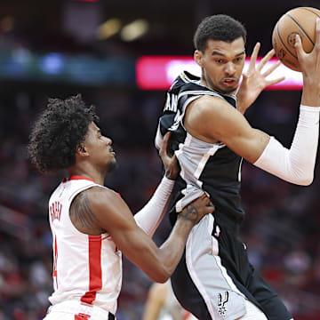 Mar 5, 2024; Houston, Texas, USA; San Antonio Spurs center Victor Wembanyama (1) controls the ball as Houston Rockets guard Jalen Green (4) defends during the first quarter at Toyota Center.