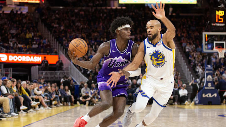 Apr 14, 2024; San Francisco, California, USA; Golden State Warriors guard Jerome Robinson (18) guards Utah Jazz forward Taylor Hendricks (0) during the fourth quarter at Chase Center. Mandatory Credit: D. Ross Cameron-Imagn Images