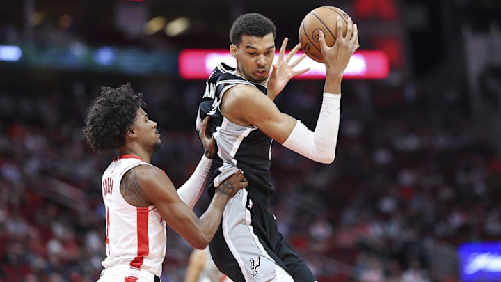 Mar 5, 2024; Houston, Texas, USA; San Antonio Spurs center Victor Wembanyama (1) controls the ball as Houston Rockets guard Jalen Green (4) defends during the first quarter at Toyota Center.