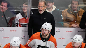 Dec 31, 2024; San Jose, California, USA; Philadelphia Flyers head coach John Tortorella reacts to game play against the San Jose Sharks as right wing Matvei Michkov (39), left wing Joel Farabee (86) and center Sean Couturier (14) watch the play during the third period at SAP Center at San Jose. Mandatory Credit: Robert Edwards-Imagn Images