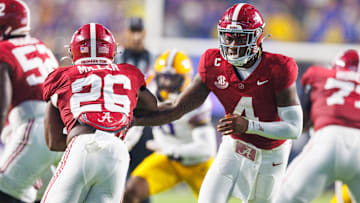 Alabama Crimson Tide quarterback Jalen Milroe (4) hands the ball off to Alabama Crimson Tide running back Jam Miller (26)