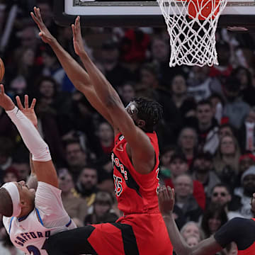 Mar 26, 2023; Toronto, Ontario, CAN; Washington Wizards center Daniel Gafford (21) drives to the basket as Toronto Raptors center Christian Koloko (35) tries to defend during the second quarter at Scotiabank Arena. Mandatory Credit: Nick Turchiaro-Imagn Images