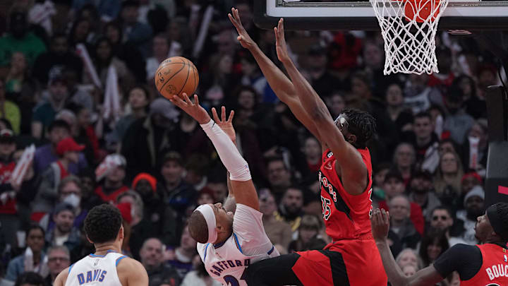 Mar 26, 2023; Toronto, Ontario, CAN; Washington Wizards center Daniel Gafford (21) drives to the basket as Toronto Raptors center Christian Koloko (35) tries to defend during the second quarter at Scotiabank Arena. Mandatory Credit: Nick Turchiaro-Imagn Images