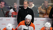 Dec 31, 2024; San Jose, California, USA; Philadelphia Flyers head coach John Tortorella reacts to game play against the San Jose Sharks as right wing Matvei Michkov (39), left wing Joel Farabee (86) and center Sean Couturier (14) watch the play during the third period at SAP Center at San Jose. Mandatory Credit: Robert Edwards-Imagn Images
