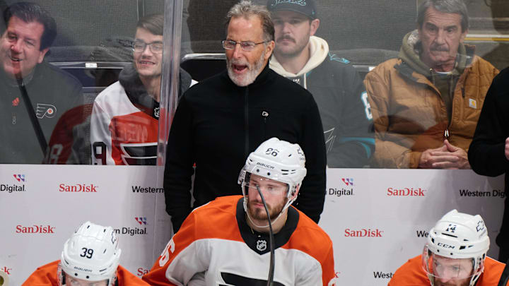 Dec 31, 2024; San Jose, California, USA; Philadelphia Flyers head coach John Tortorella reacts to game play against the San Jose Sharks as right wing Matvei Michkov (39), left wing Joel Farabee (86) and center Sean Couturier (14) watch the play during the third period at SAP Center at San Jose. Mandatory Credit: Robert Edwards-Imagn Images Dec 31, 2024; San Jose, California, USA; Philadelphia Flyers head coach John Tortorella reacts to game play against the San Jose Sharks as right wing Matvei Michkov (39), left wing Joel Farabee (86) and center Sean Couturier (14) watch the play during the third period at SAP Center at San Jose. Mandatory Credit: Robert Edwards-Imagn Images