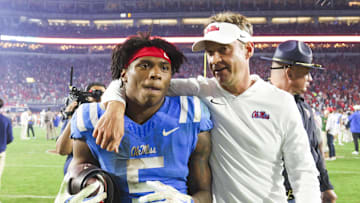 Nov 15, 2025; Oxford, Mississippi, USA; Mississippi Rebels head coach Lane Kiffin embraces running back Kewan Lacy (5) after defeating the Florida Gators at Vaught-Hemingway Stadium. Mandatory Credit: Petre Thomas-Imagn Images