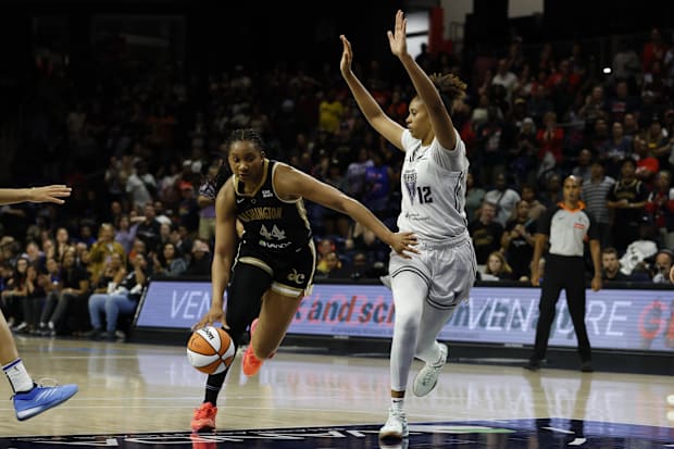 Washington Mystics forward Kiki Iriafen drives to the basket as Golden State Valkyries center Iliana Rupert defends.